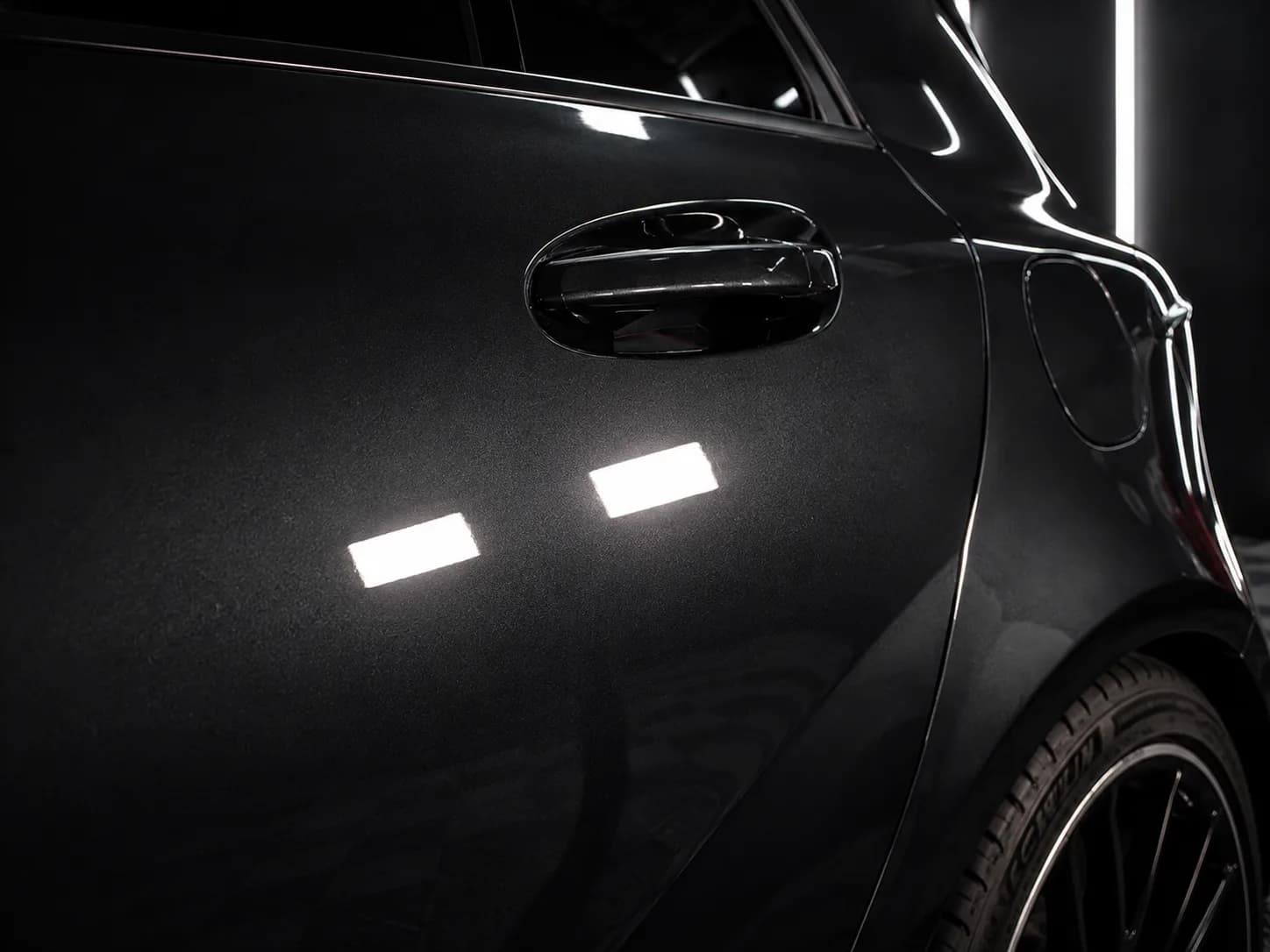 Black car detail under studio lights